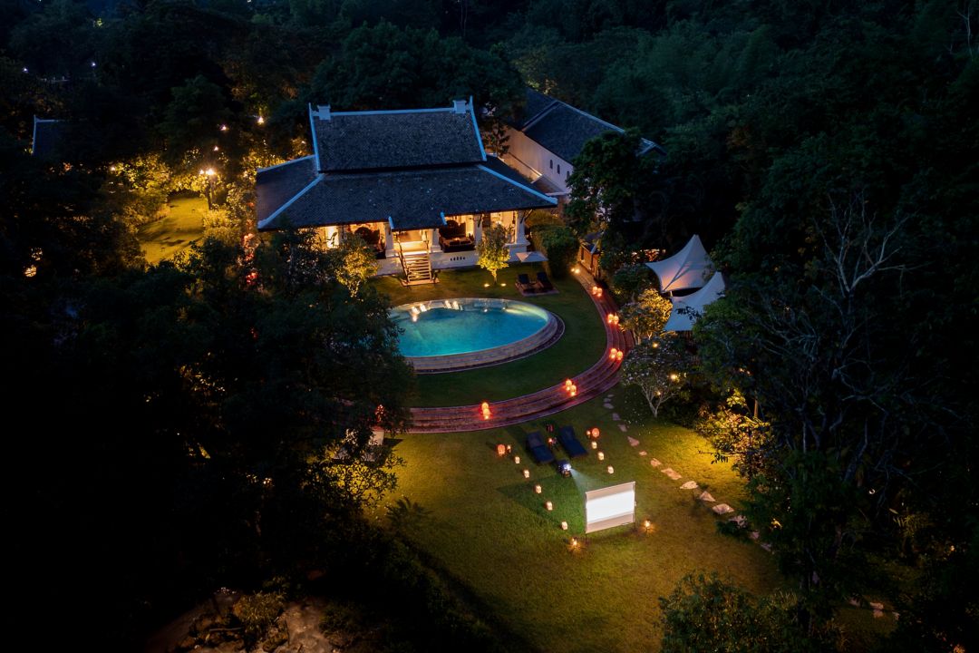 watching movies by the pool at luxury hotel in Laos